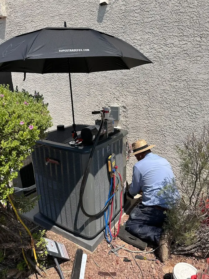 HVAC technician performing outdoor AC maintenance in Swanton