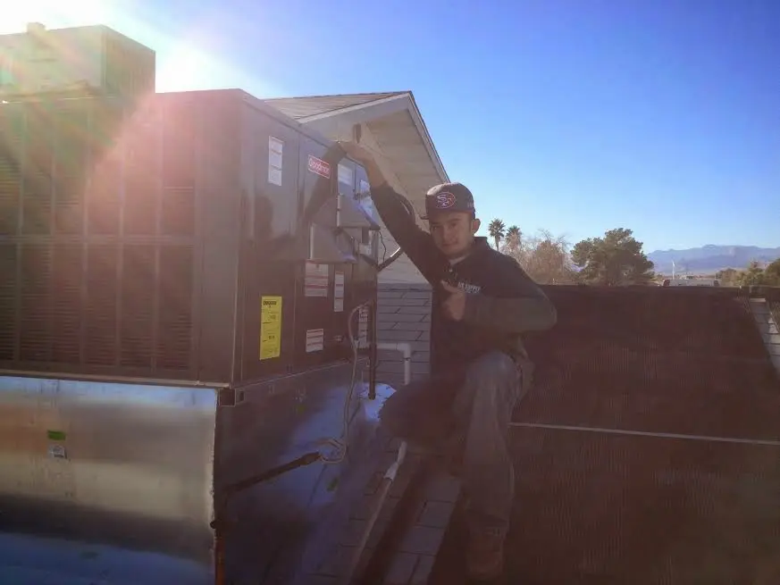 HVAC technician performing HVAC Inspection on a rooftop unit in Swanton